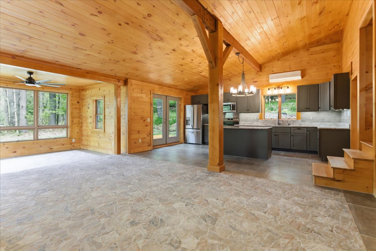 203 Belgrade Rd — open main level with vaulted T&G pine ceiling and kitchen